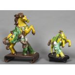 Two Chinese pottery Tang style horse groups Each formed as rearing horse and groom,