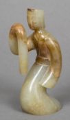 A Chinse carved celadon and russet jade dancing figure 10.5 cm high.