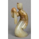 A Chinse carved celadon and russet jade dancing figure 10.5 cm high.