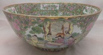 A Chinese porcelain punch bowl Decorated with figural vignettes on a floral ground,