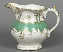 A 19th century Rockingham porcelain jug With green and gilt scrolling decorations and initialled JM;