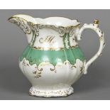 A 19th century Rockingham porcelain jug With green and gilt scrolling decorations and initialled JM;