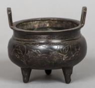 A Chinese cast bronze twin handled censor Decorated with a pair of temple lions in a continuous