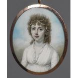 An early 19th century portrait miniature on ivory Depicting a young girl with pearls in her hair,