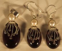 A silver dress earring and pendant set