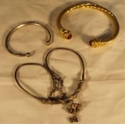 An Indian silver necklace and two torques