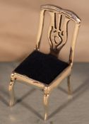 A miniature silver chair