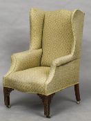 A Chippendale style mahogany upholstered wing back armchair Of typical form,