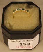 A 14 k gold and emerald half eternity ring