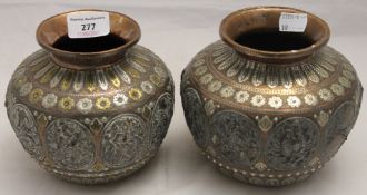 A pair of 19th century Indian unmarked silver and yellow metal mounted copper vases