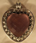A silver and pink stone heart pendant
