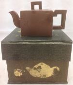 A Chinese Yixing pottery teapot and cover Of trapezoid section with angular handle and spout,