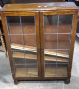 An early 20th century oak glazed display cabinet