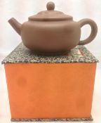 A Chinese Yixing pottery teapot and cover Of typical form,
