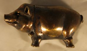 A brass pig form vesta