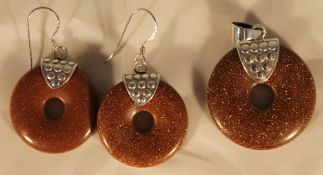 A silver dress earring and pendant set of circular form