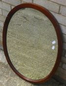 An Edwardian mahogany oval mirror