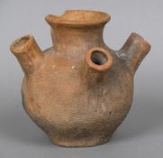 A pottery vessel, the baluster body with four protruding spouts. 20 cm high.