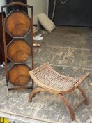 An early 20th century walnut cake stand and a caned stool