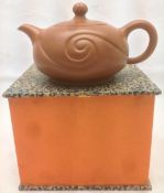 A Chinese Yixing pottery teapot and cover The body with scrolled decoration,