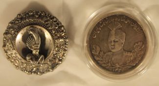 A silver turban brooch and a silver coin