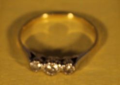 An 18 ct gold three stone diamond ring