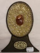 A Chinese jade plaque in brass frame