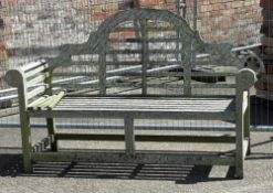 A wooden camel back garden bench