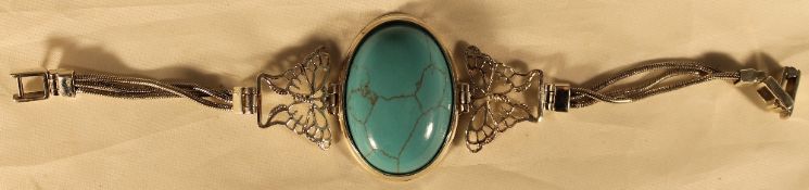 A silver and turquoise bracelet