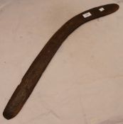 A 19th century Aboriginal carved boomerang with channelled decoration. Approximately 71 cm long.