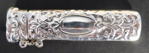 A large silver needle case