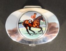 A silver pill box depicting a horse