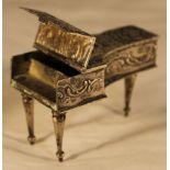 A miniature silver piano