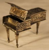 A miniature silver piano