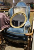 An upholstered wing back armchair