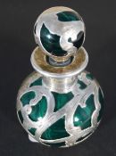 A green glass scent bottle with silver overlays