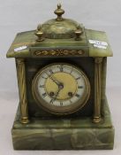 A brass mounted onyx mantle clock