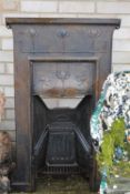 An Art Nouveau cast iron fire place