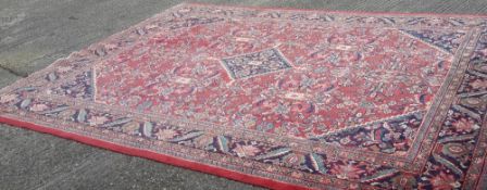 A large red ground rug (400 x 293 cm)