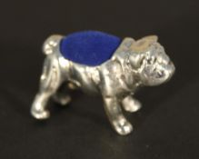 A silver pin cushion in the form of a bulldog