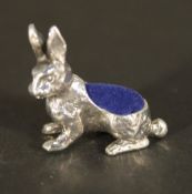 A silver pin cushion in the form of a rabbit