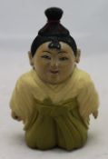 A small carved wooden Oriental figure