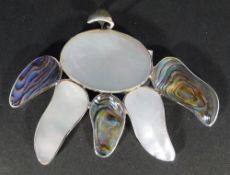 A silver and shell pendant