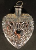 A silver perfume bottle in the form of a heart