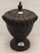 A cast iron lidded urn