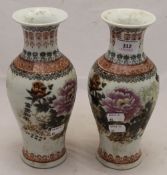 A pair of Chinese porcelain vases decorated with flowers