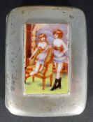 A silver cigarette case depicting two semi clothed girls