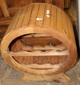 A pine wine rack in barrel form