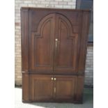 A large Georgian and later panel oak cupboard