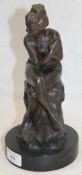 A bronze model of a nude woman